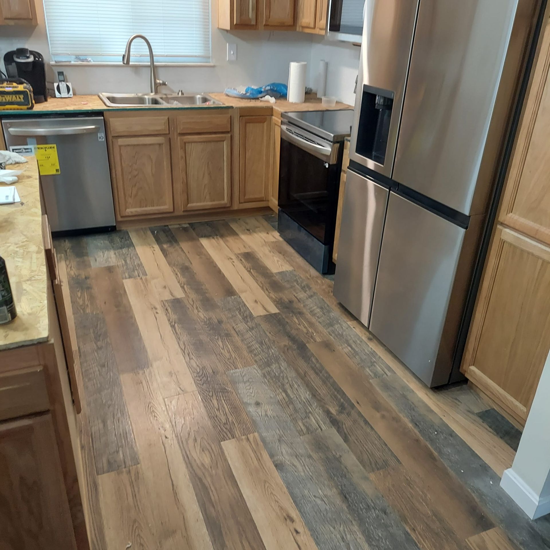 A kitchen with stainless steel appliances and wooden cabinets