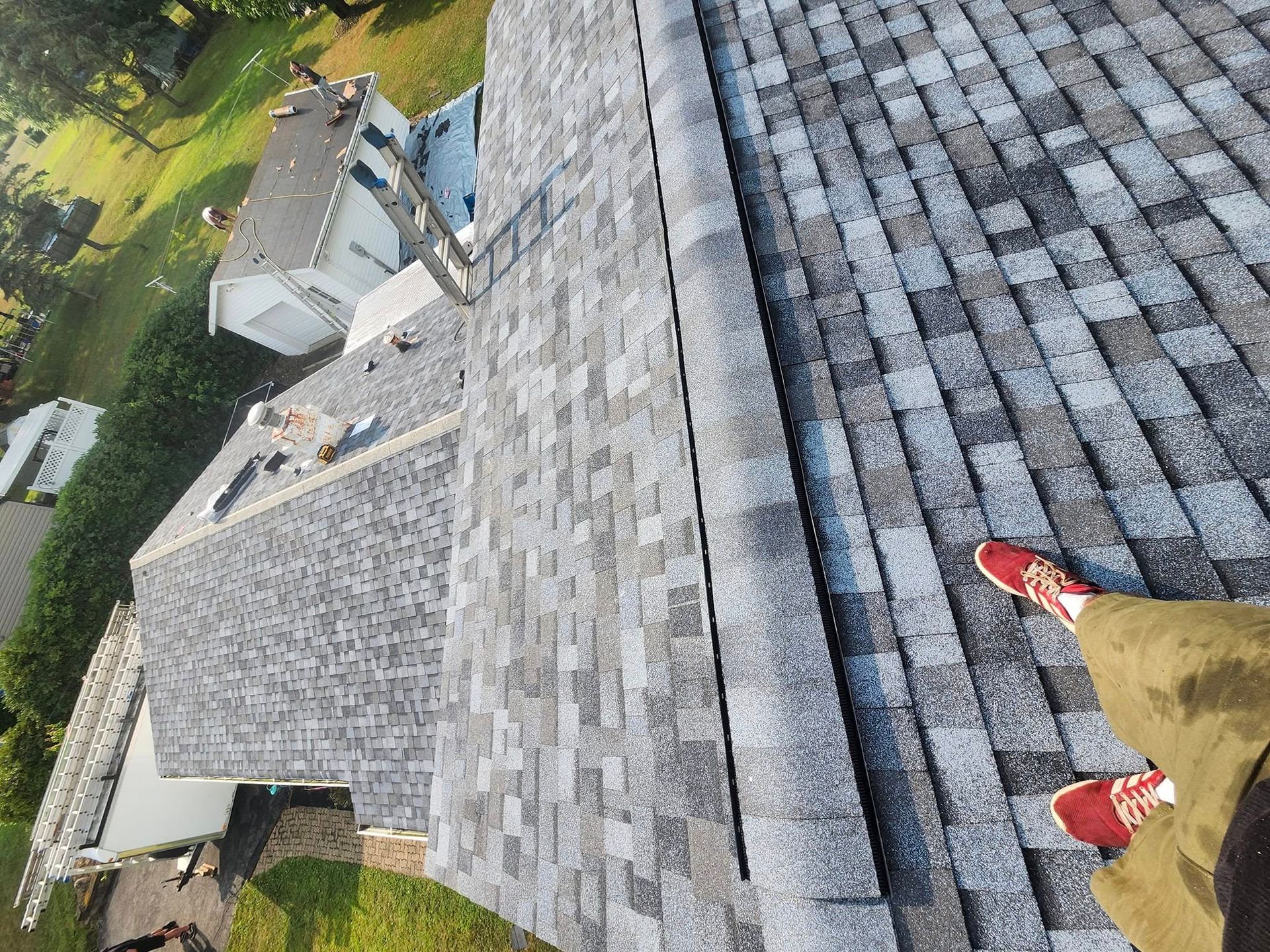 A person is standing on top of a roof.