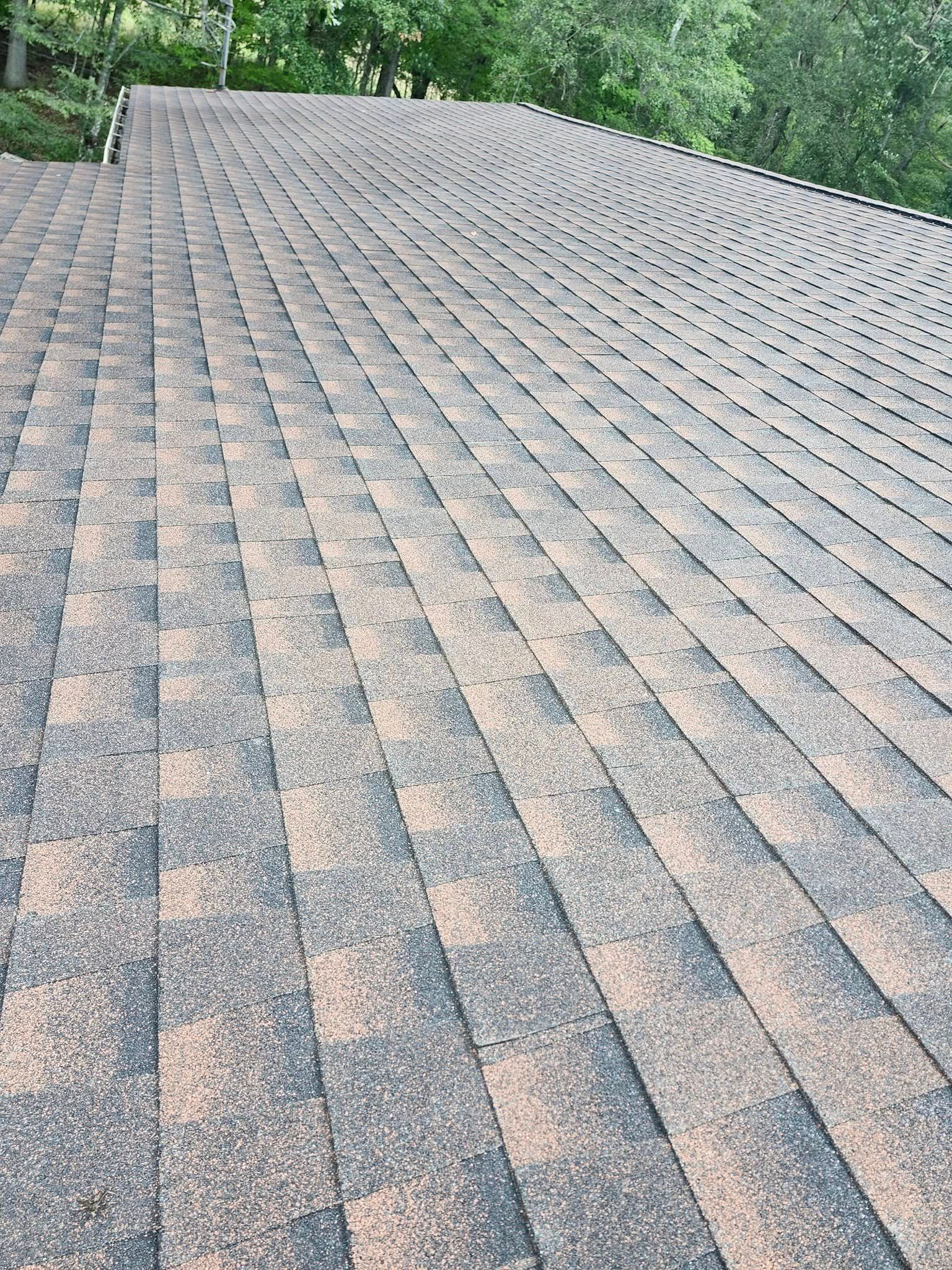A close up of a roof with a lot of shingles on it.