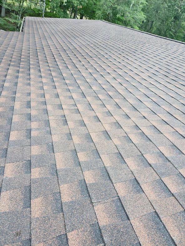 A close up of a roof with a lot of shingles on it.