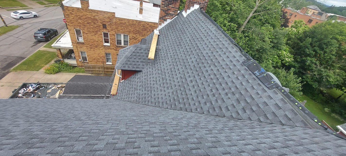 An aerial view of a house with a roof that is being repaired.