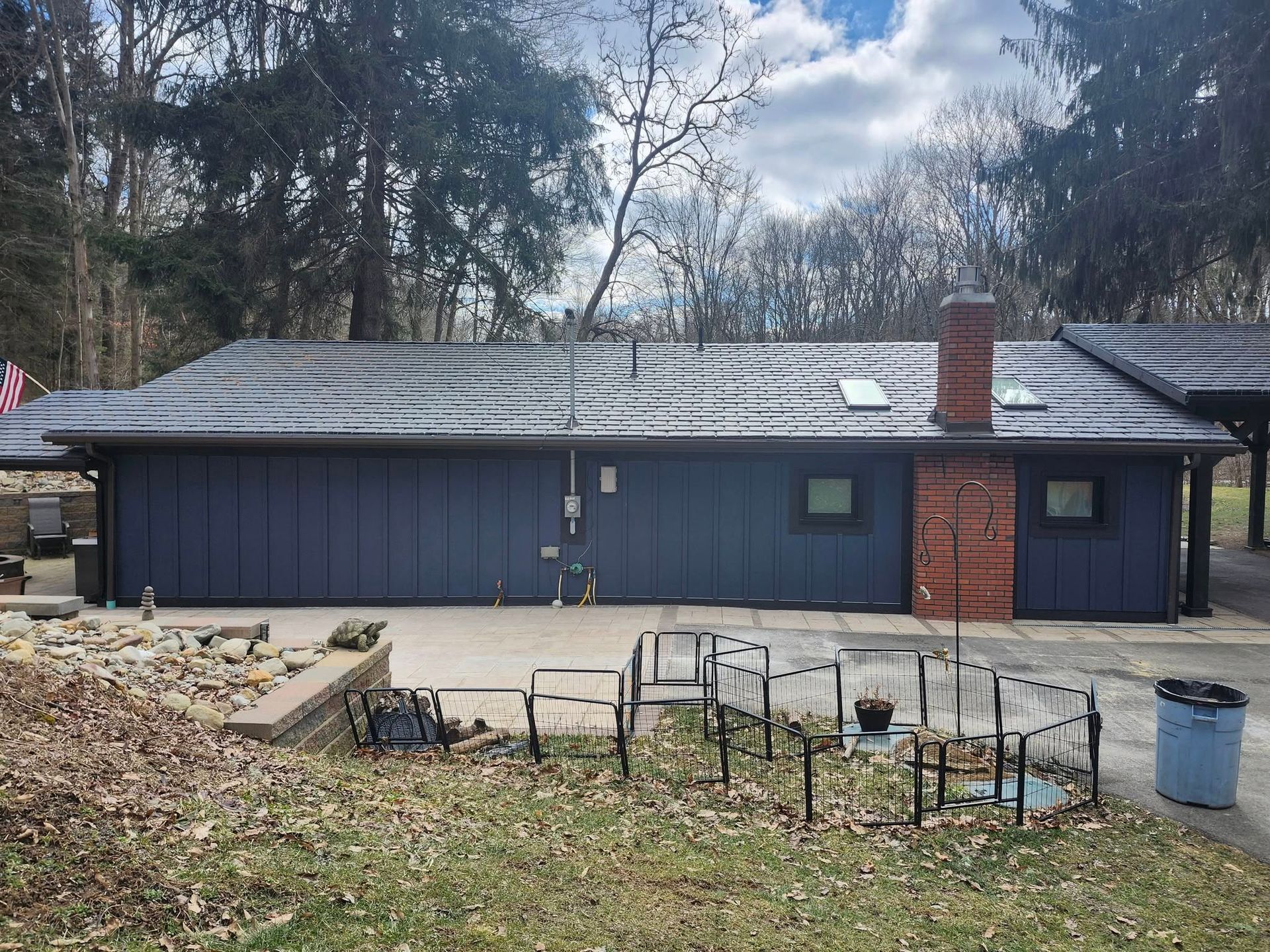 A blue house with a chimney on the roof
