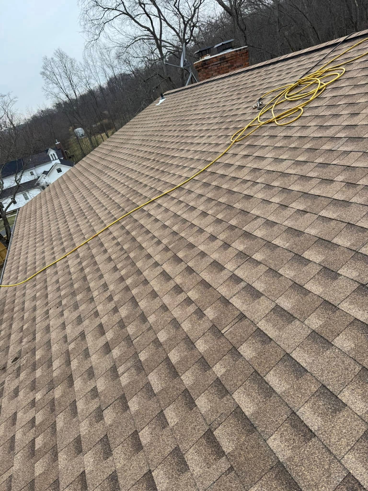 A close up of a roof with a lot of shingles on it.