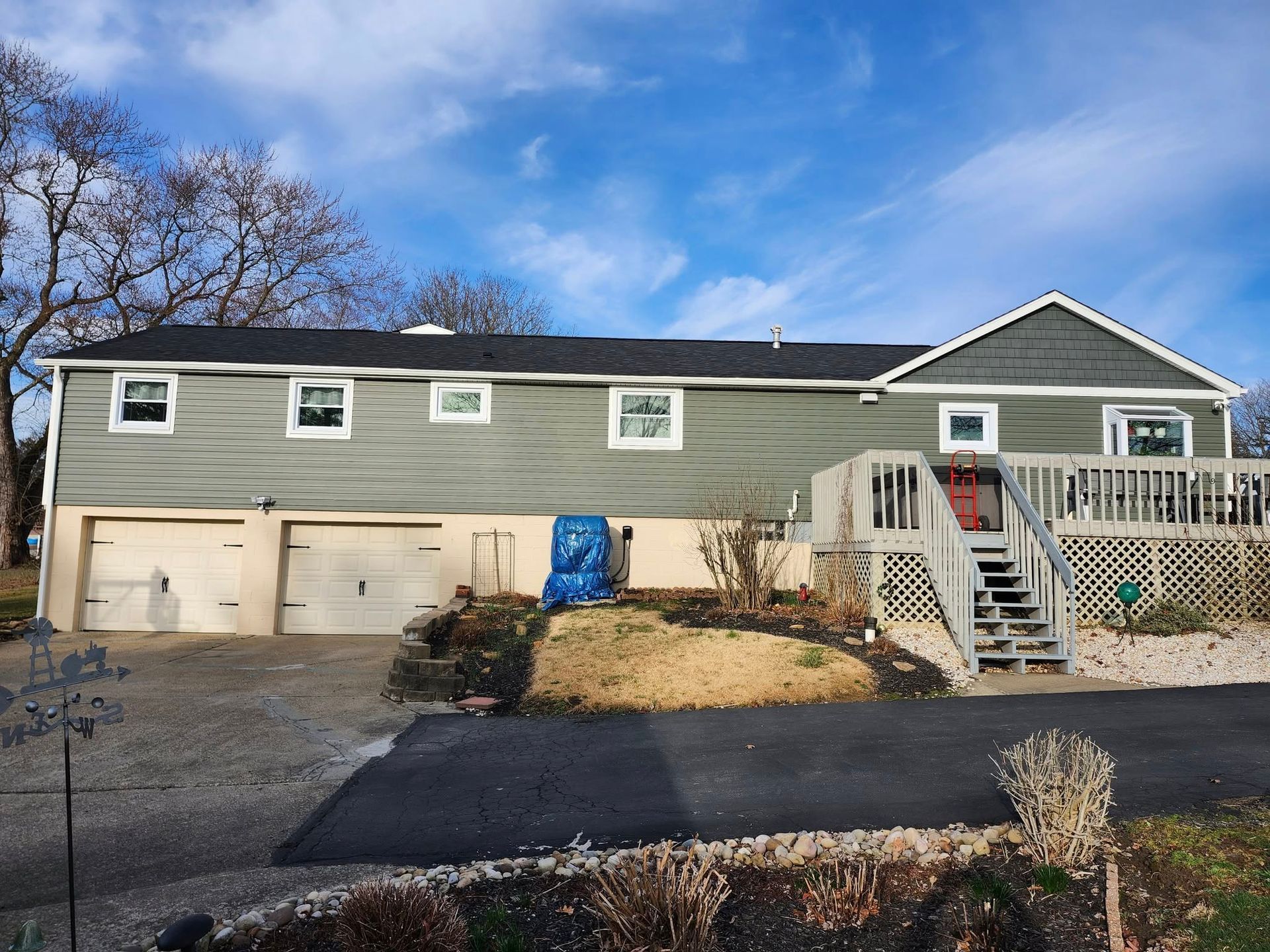 A large house with two garages and a deck