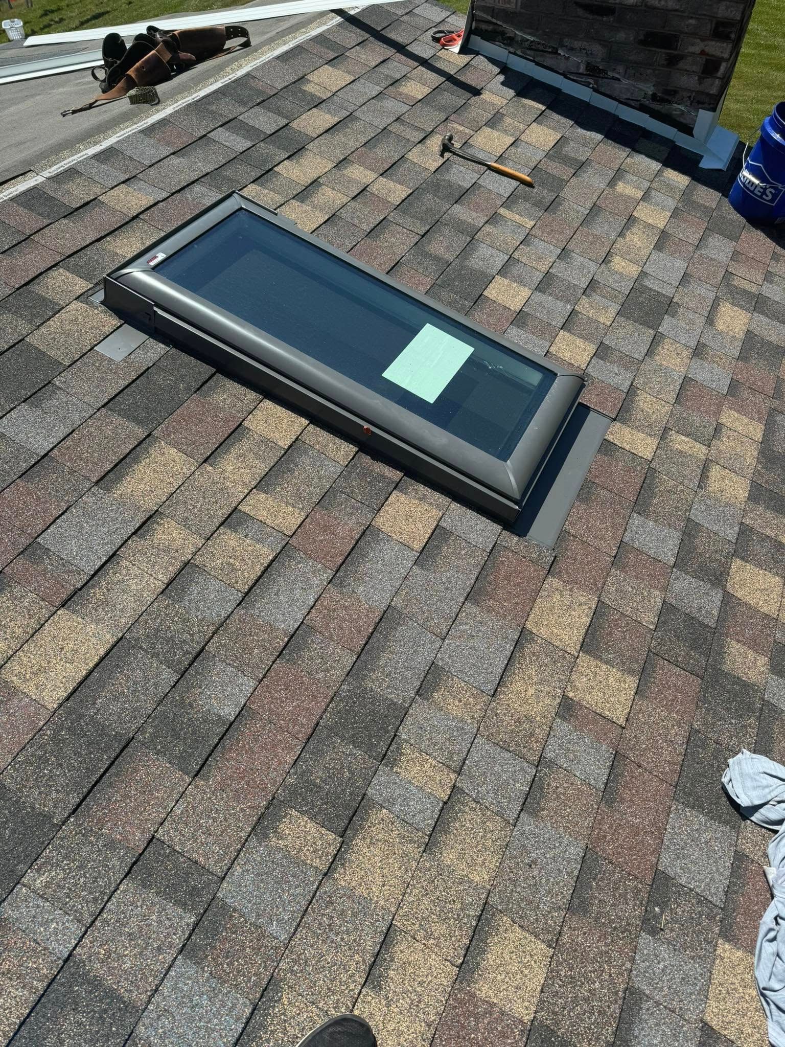 A skylight is sitting on top of a roof.
