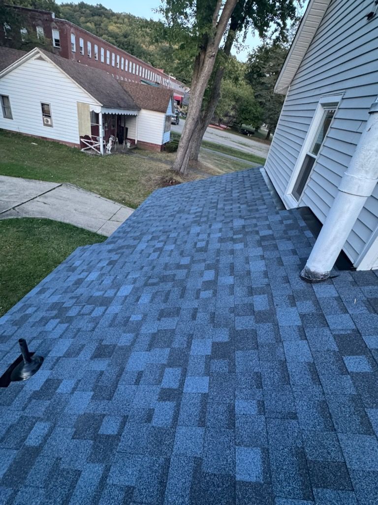 A close up of a roof with a lot of shingles on it.