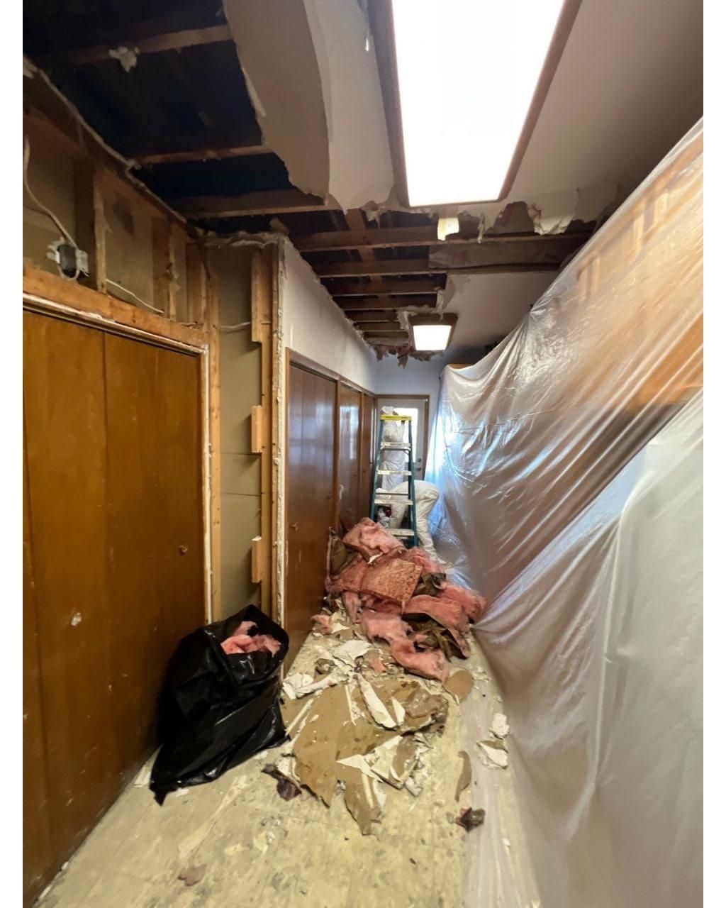 A hallway with a lot of trash on the floor