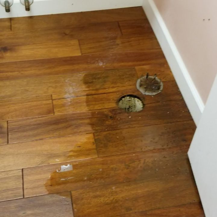 A wooden floor with a hole in the middle of it
