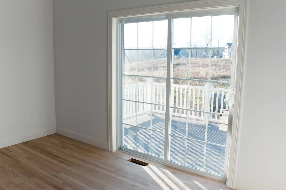 A sliding glass door in a new construction's empty room at Interior Views near Manasquan, New Jersey (NJ)