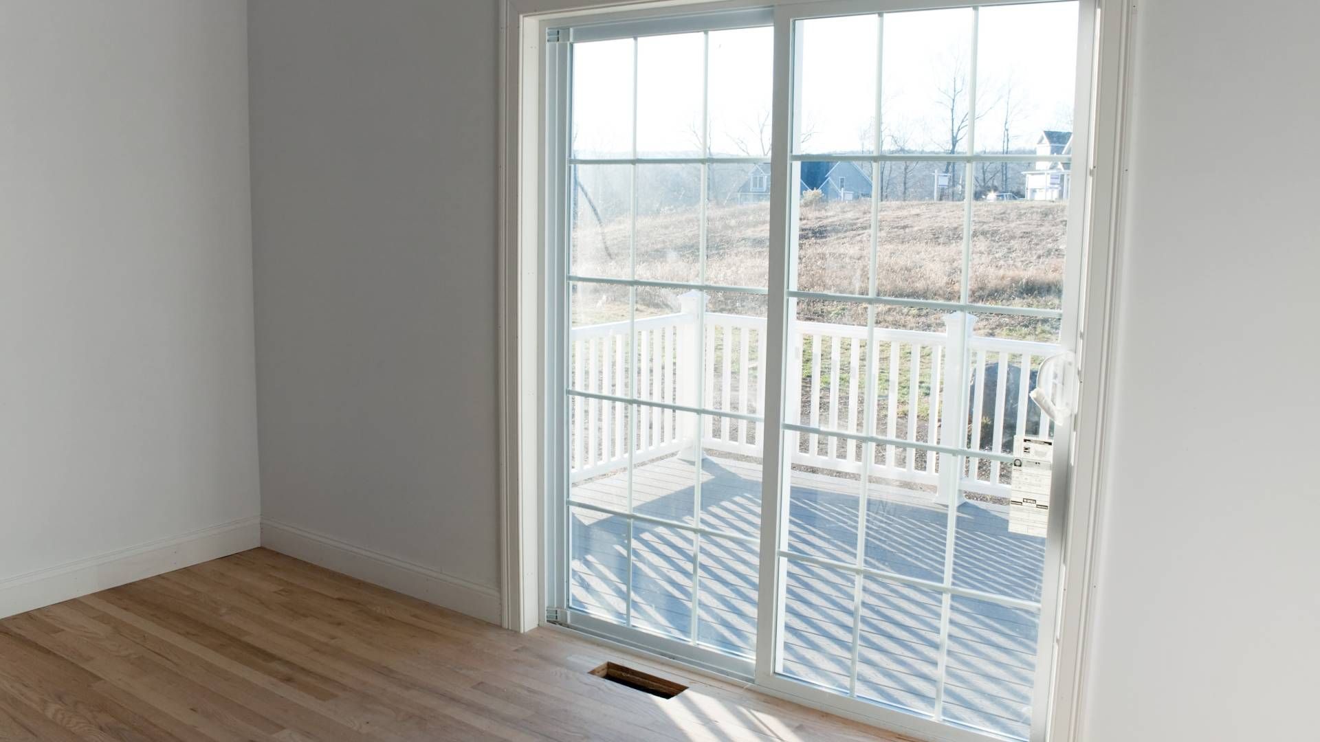 A sliding glass door in a new construction's empty room at Interior Views near Manasquan, New Jersey