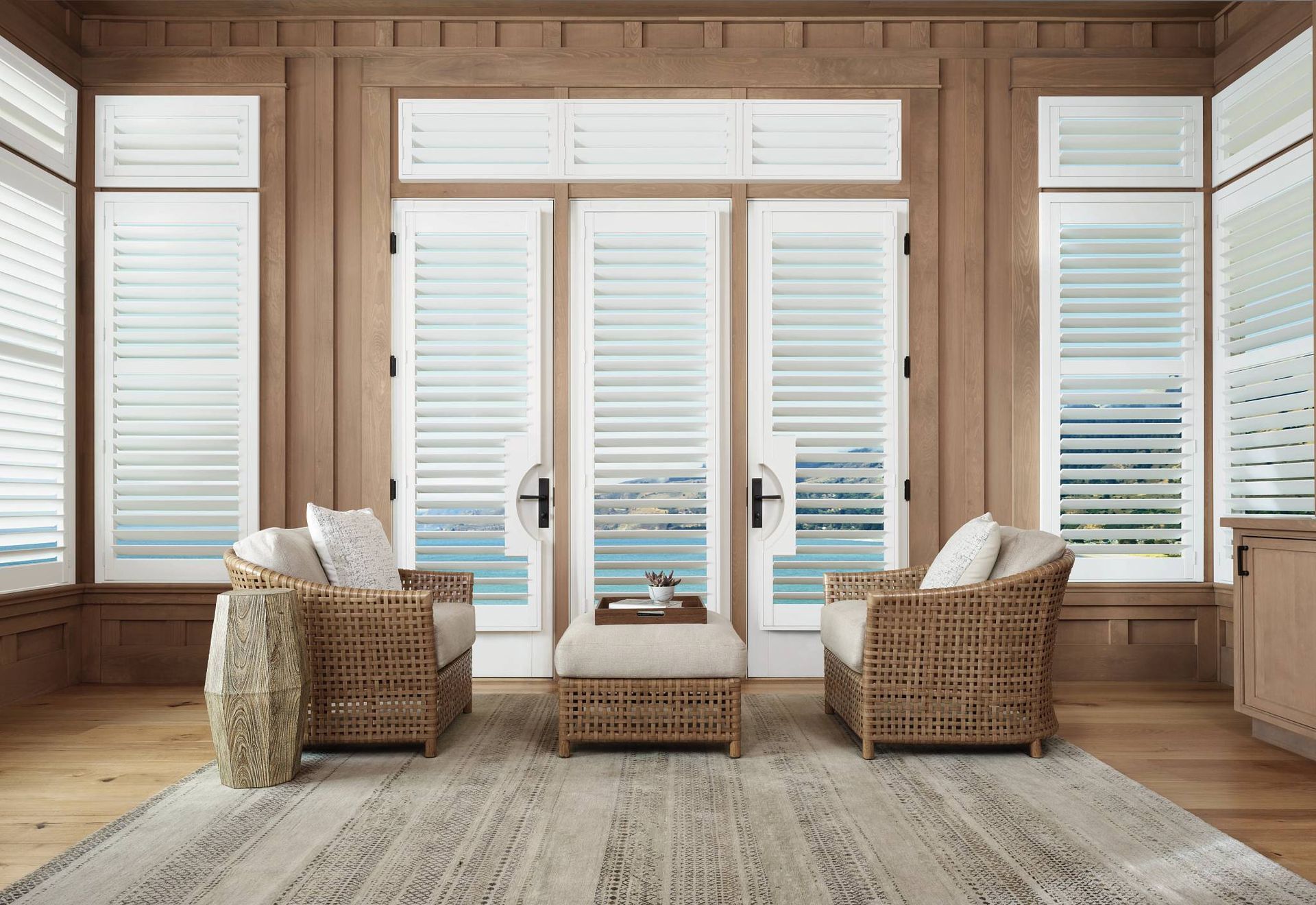 Hunter Douglas Palm Beach® Polysatin™ Vinyl Shutters in a coastal living room near Manasquan, NJ