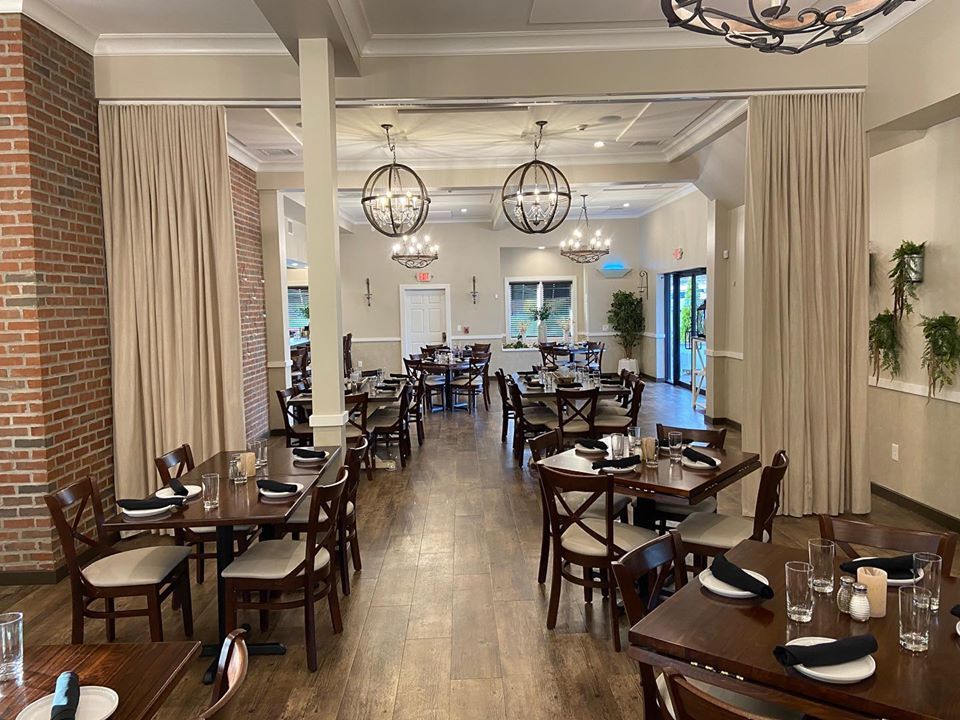 A restaurant dining space with drapery as room dividers