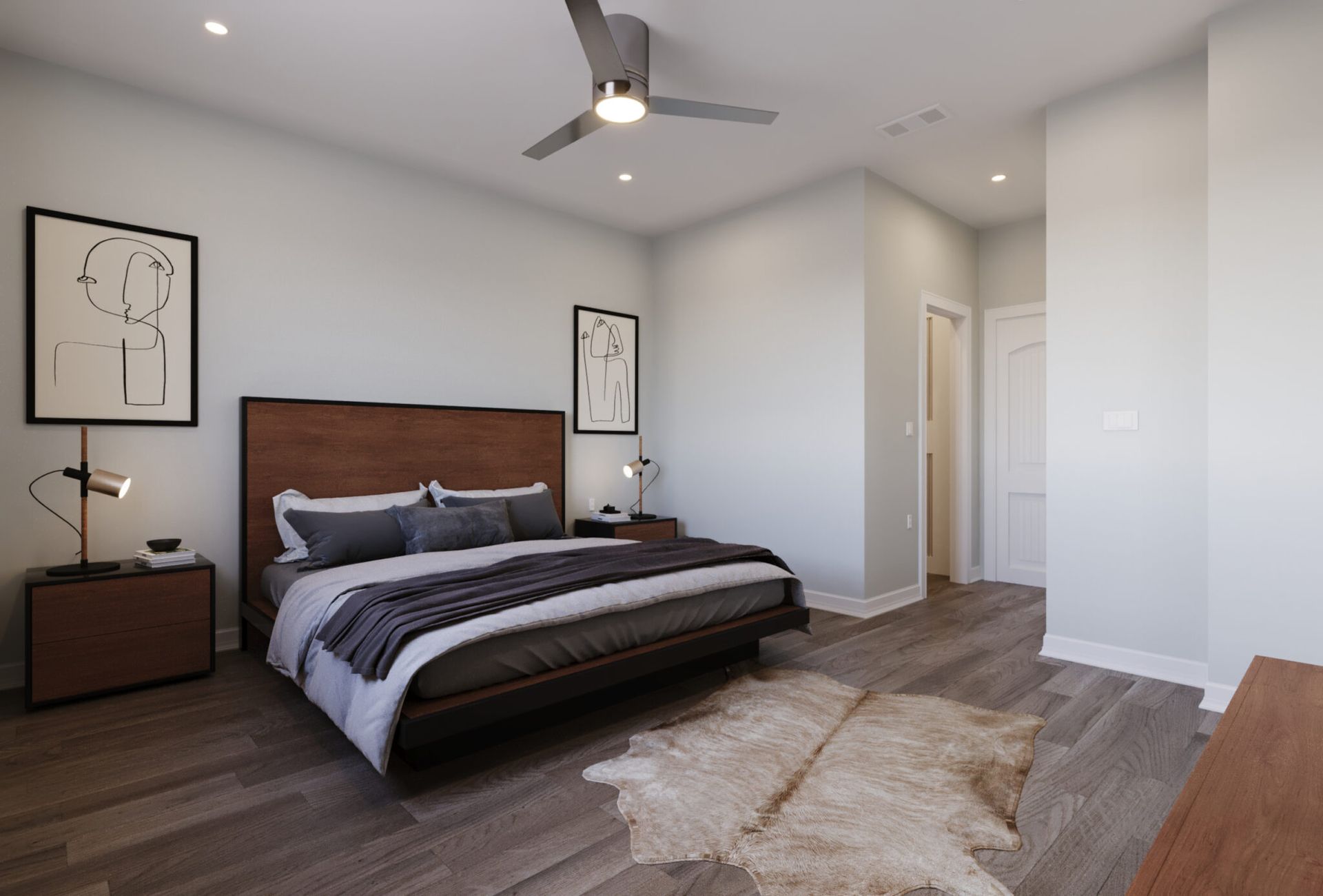 A bedroom with a large bed and a ceiling fan.