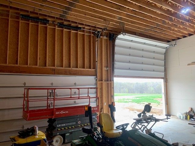 A tractor is parked in a garage under construction.
