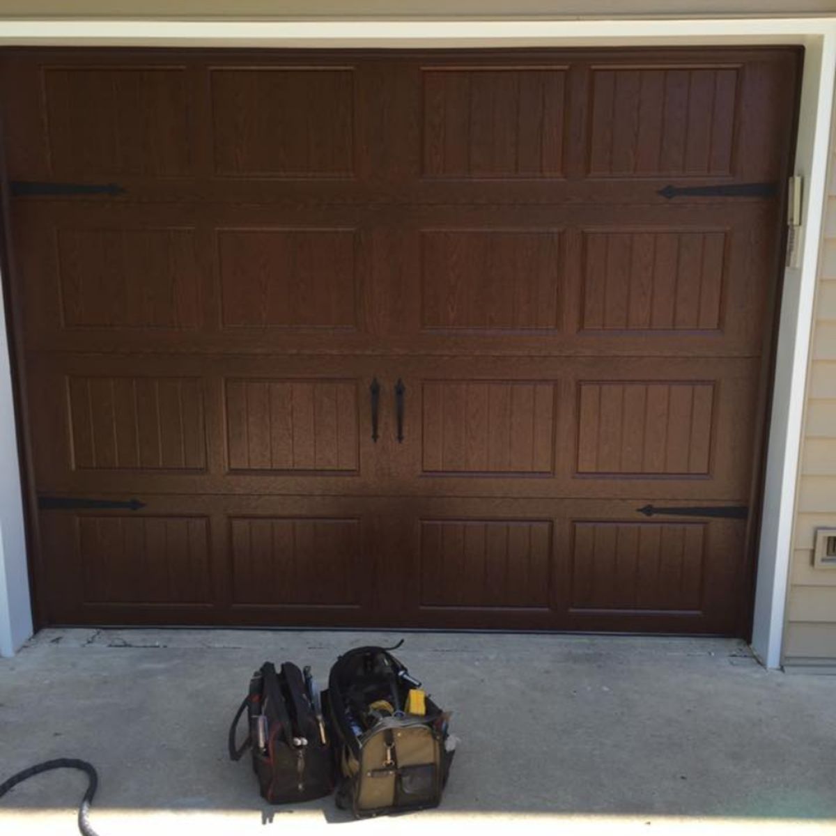 Technician performing garage door maintenance check in Excelsior Springs MO 