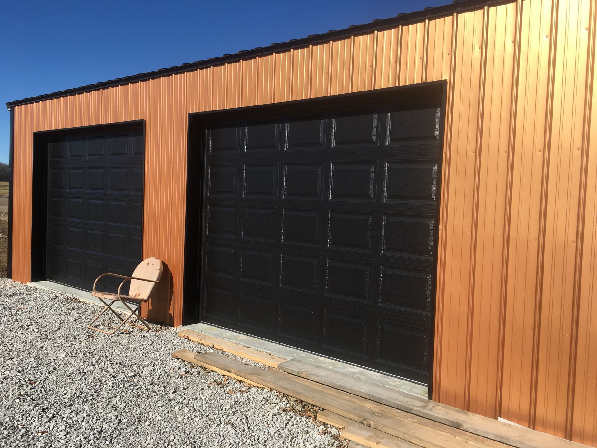 A row of garage doors with a chair in front of them