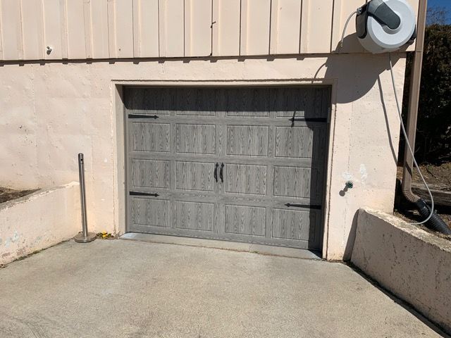 A garage door with a hose attached to it.
