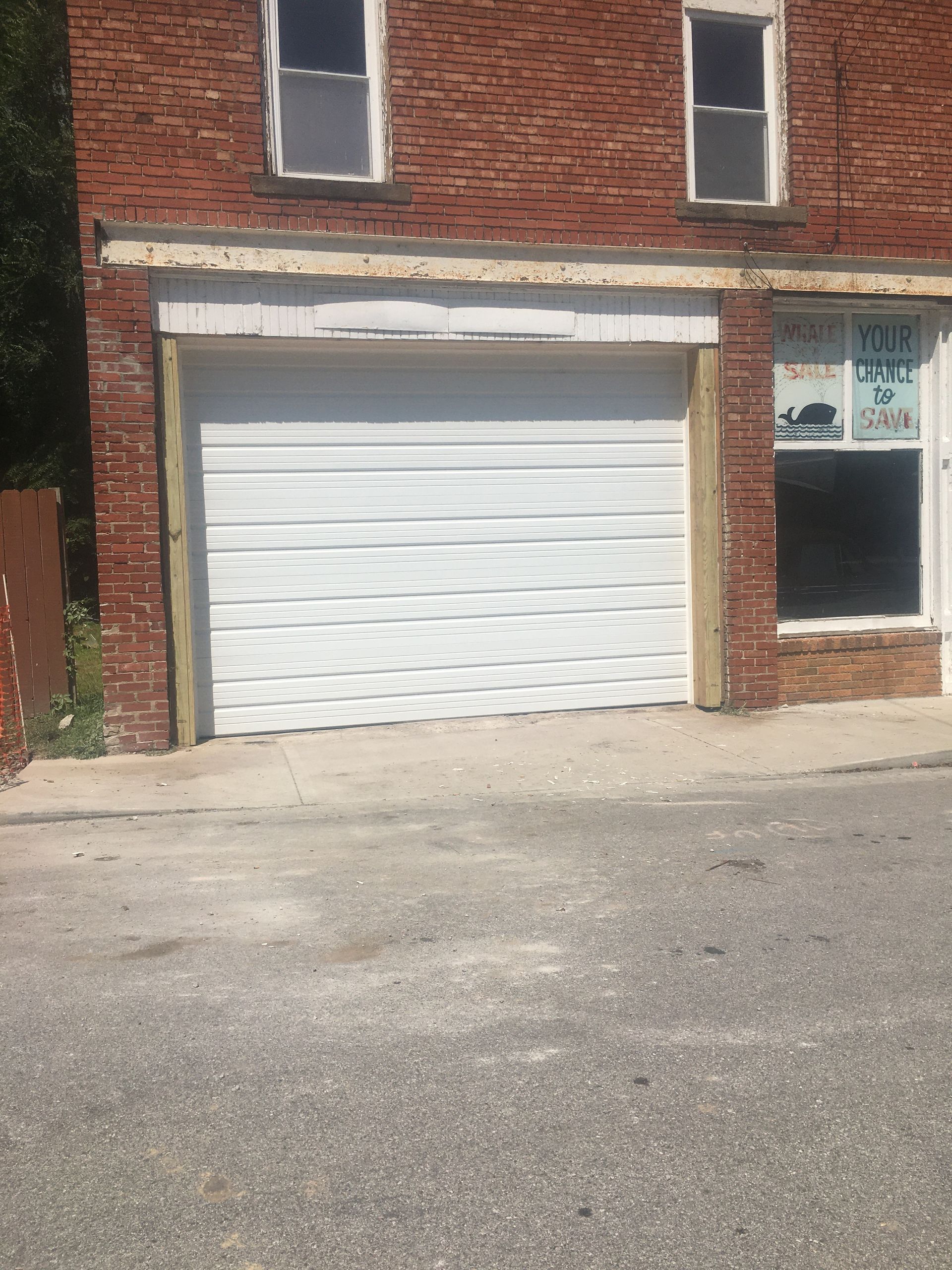 A brick building with a white garage door
