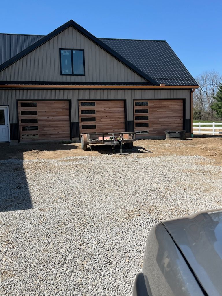A house with a trailer parked in front of it.