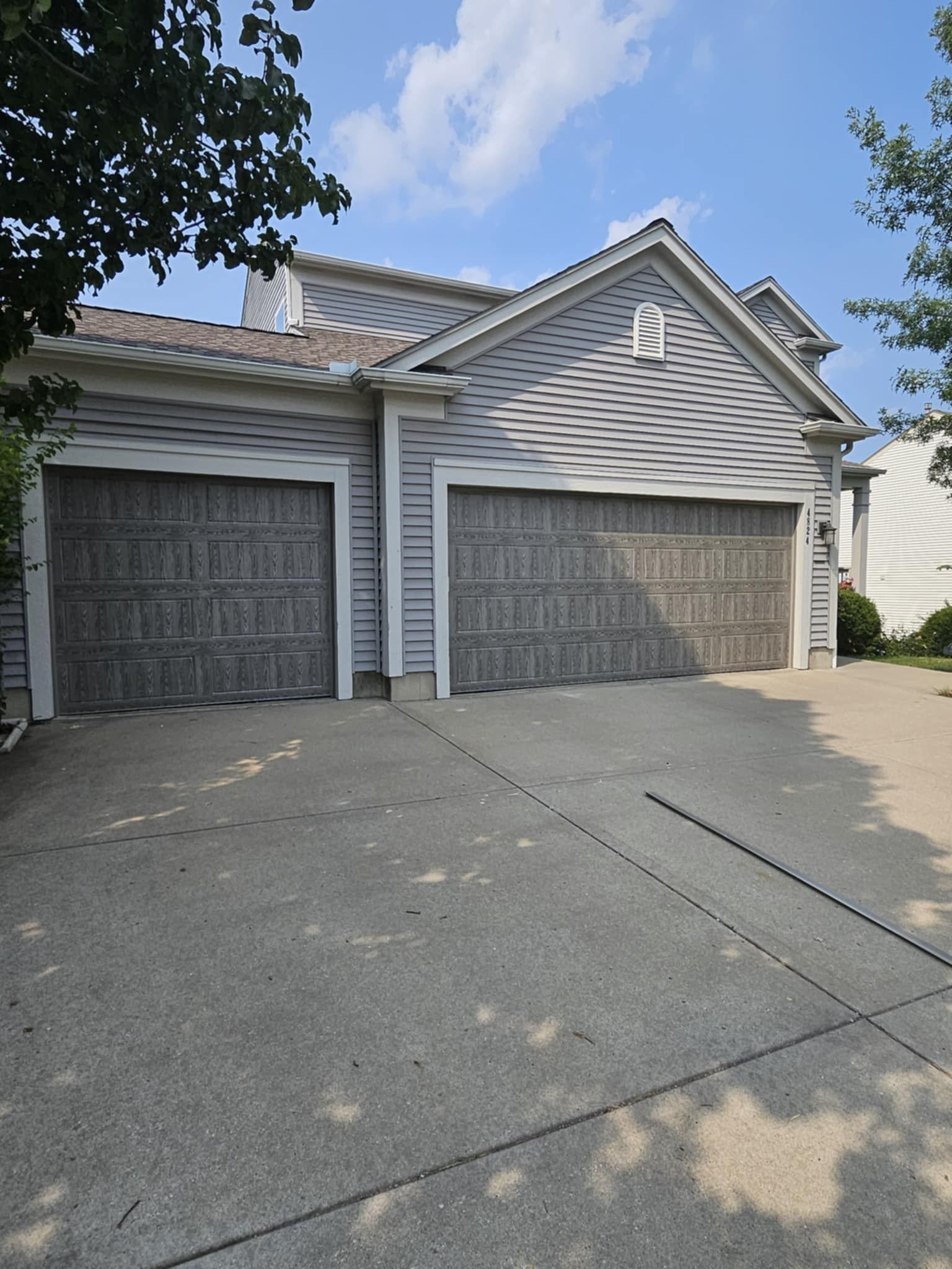 A house with two garage doors and a driveway