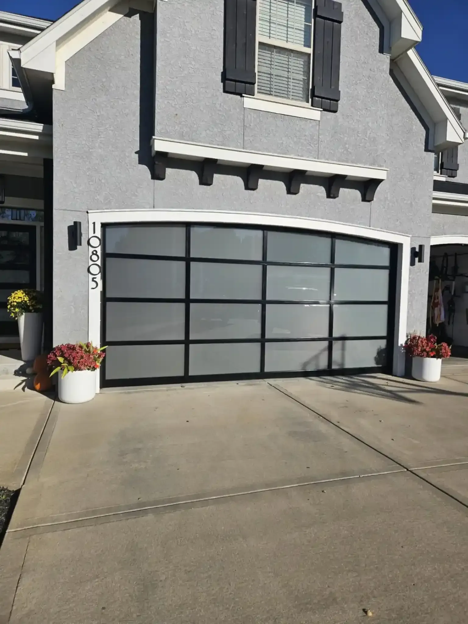 Homeowner comparing garage door styles and materials for residential installation in Excelsior Springs MO