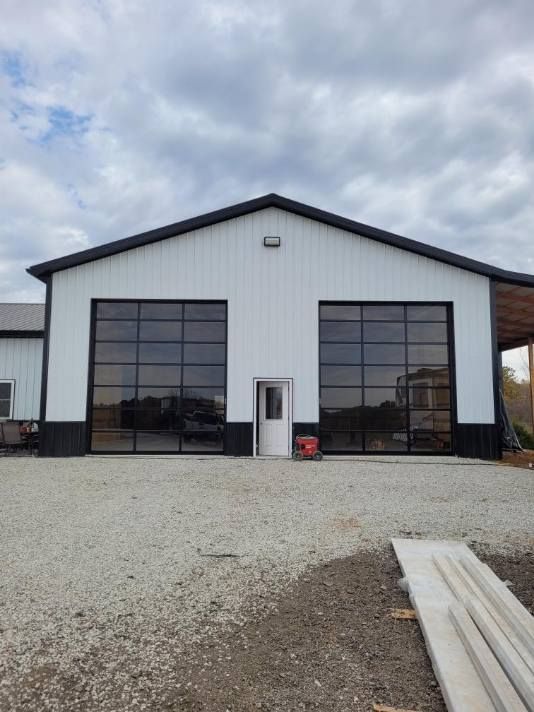 A large white building with a large garage door