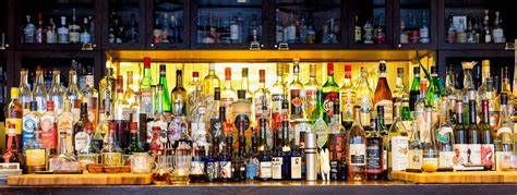 A bar filled with lots of bottles of alcohol