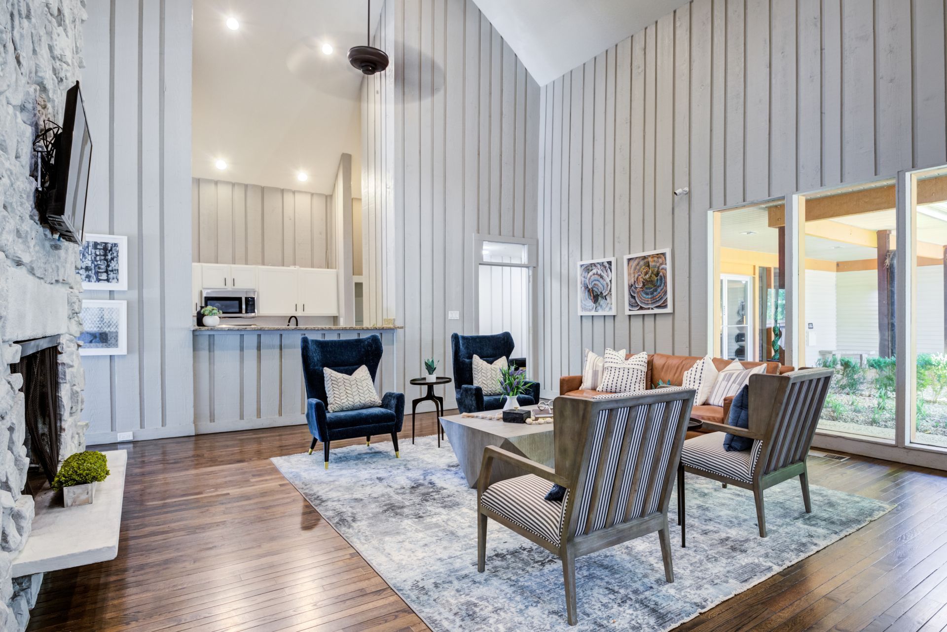 Poolside view with lounge chairs, blue pool, and a building.