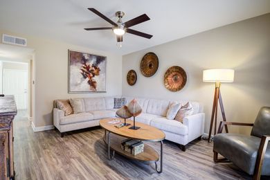 Two lounge chairs are sitting next to a swimming pool at Overbrook Apartments.