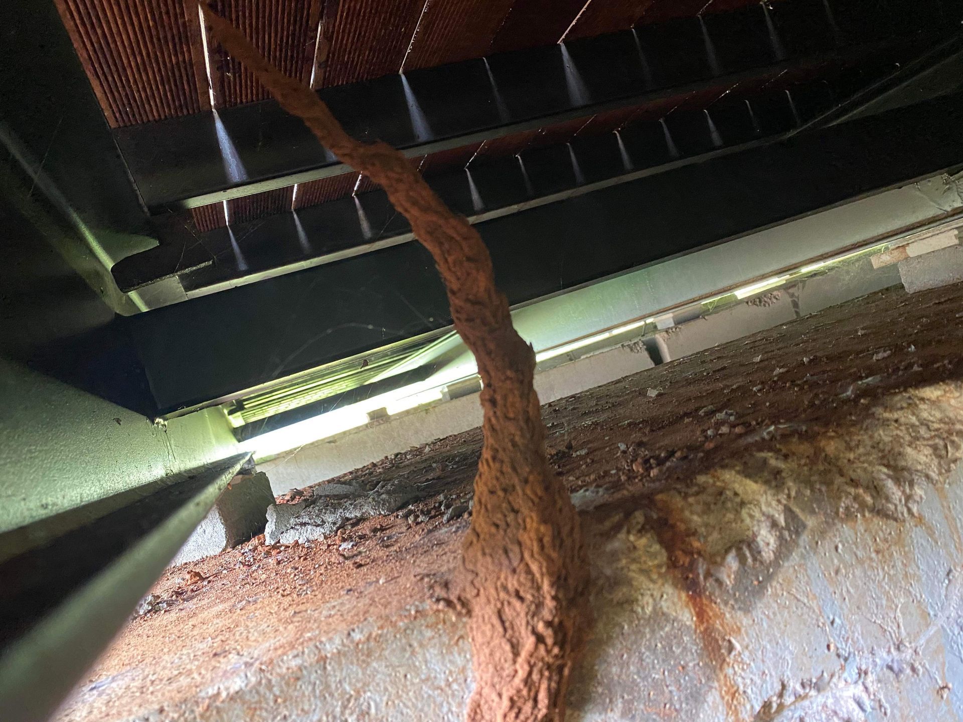 A close up of a rusty piece of metal in a room.