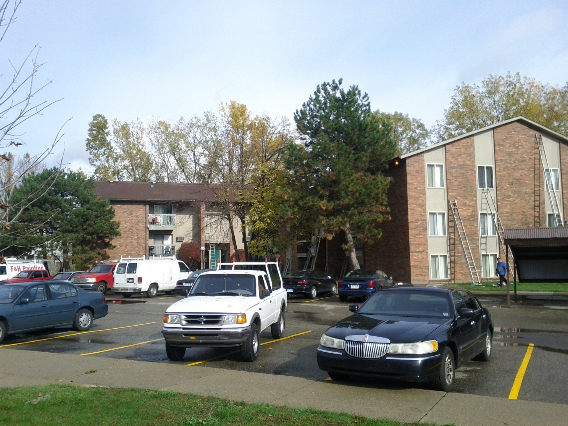F&H Painting's white van with other cars in the parking lot
