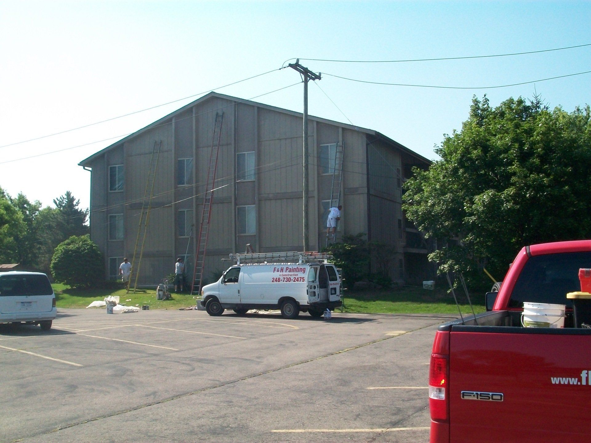 F&H Painting's white van parked in front of the house they are working
