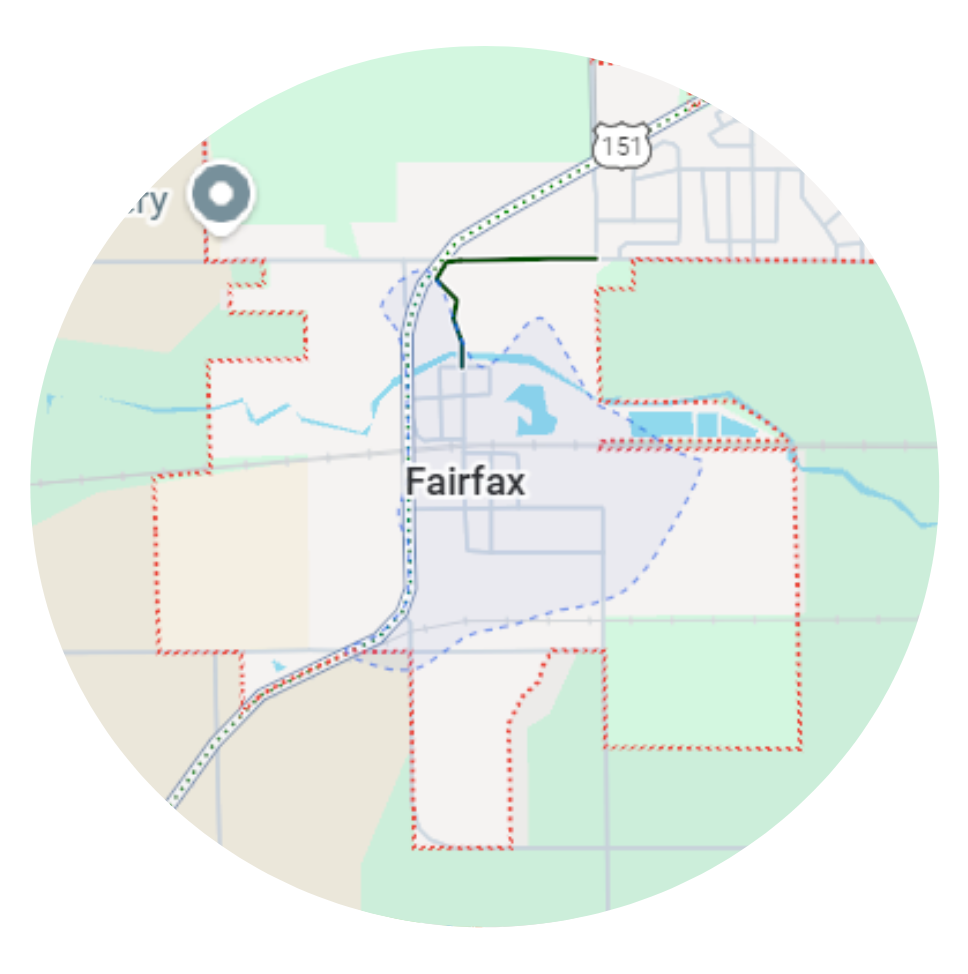 Map of Fairfax, Iowa, with highlighted roads and surrounding areas in a circular frame.