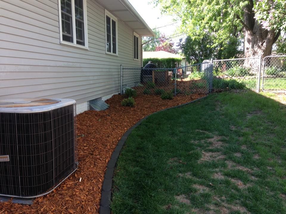 A house with a air conditioner in the backyard.