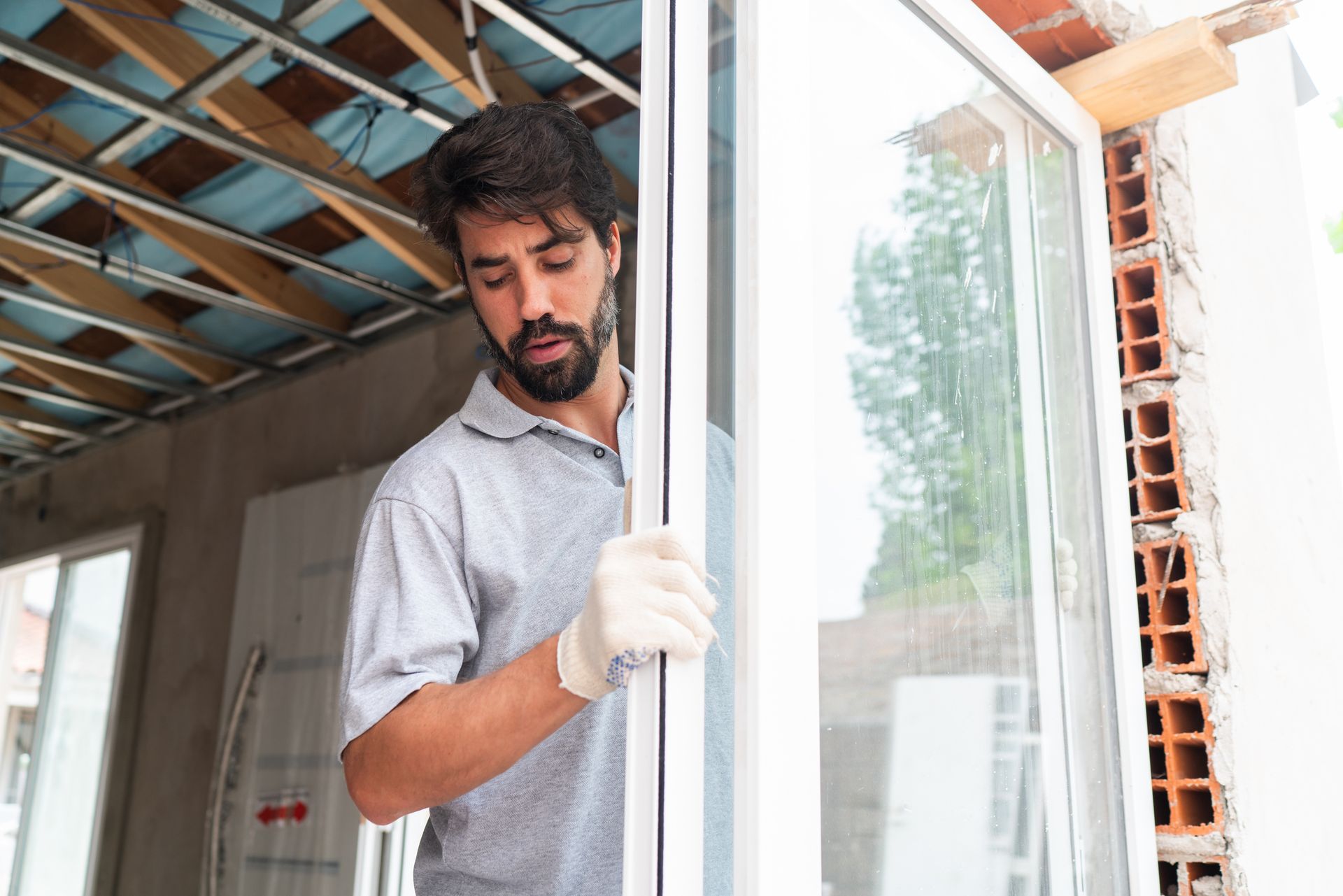 Contractor installing new windows on site, showcasing excellent window glass replacement