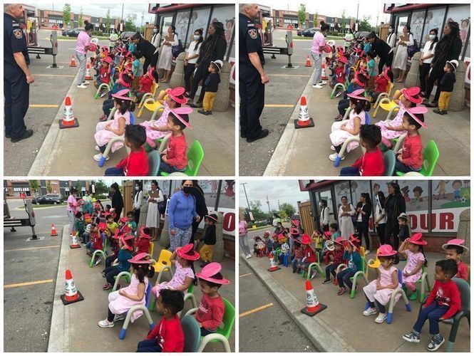 Children in colorful clothes sit in chairs outdoors, possibly at a daycare. Police officers supervise.