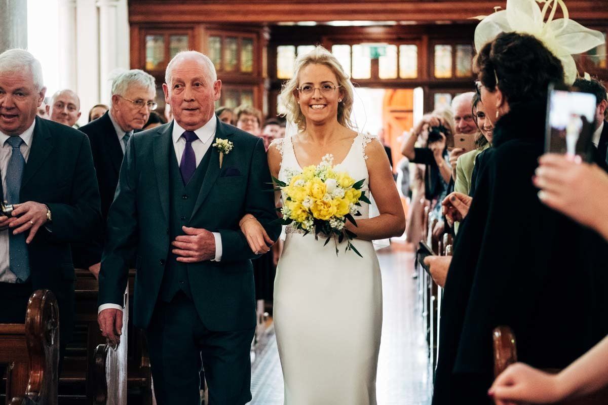 Bride and father walking down the aisle at Blessed Virgin Mary Timoleague