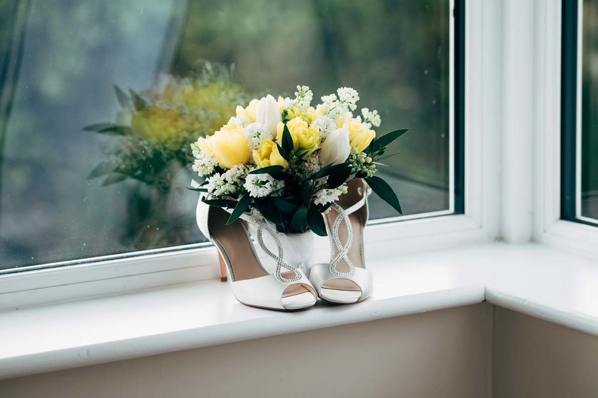 Wedding flowers and shoes on window cill