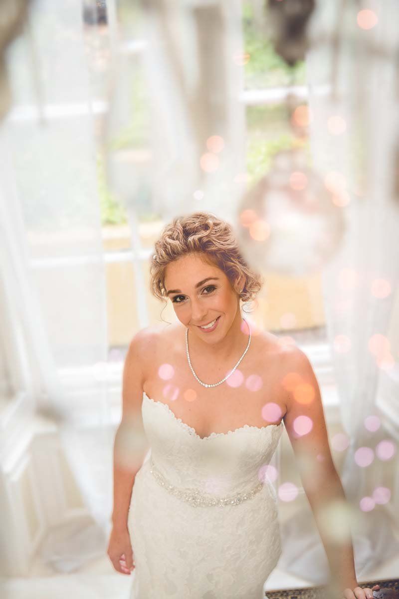 Ballinacurra House wedding bride standing at landing with glass chandelier 