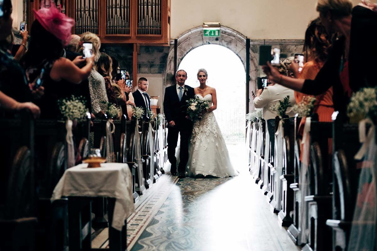 bride and father walking down aisle at Honan Chapel UCC Cork