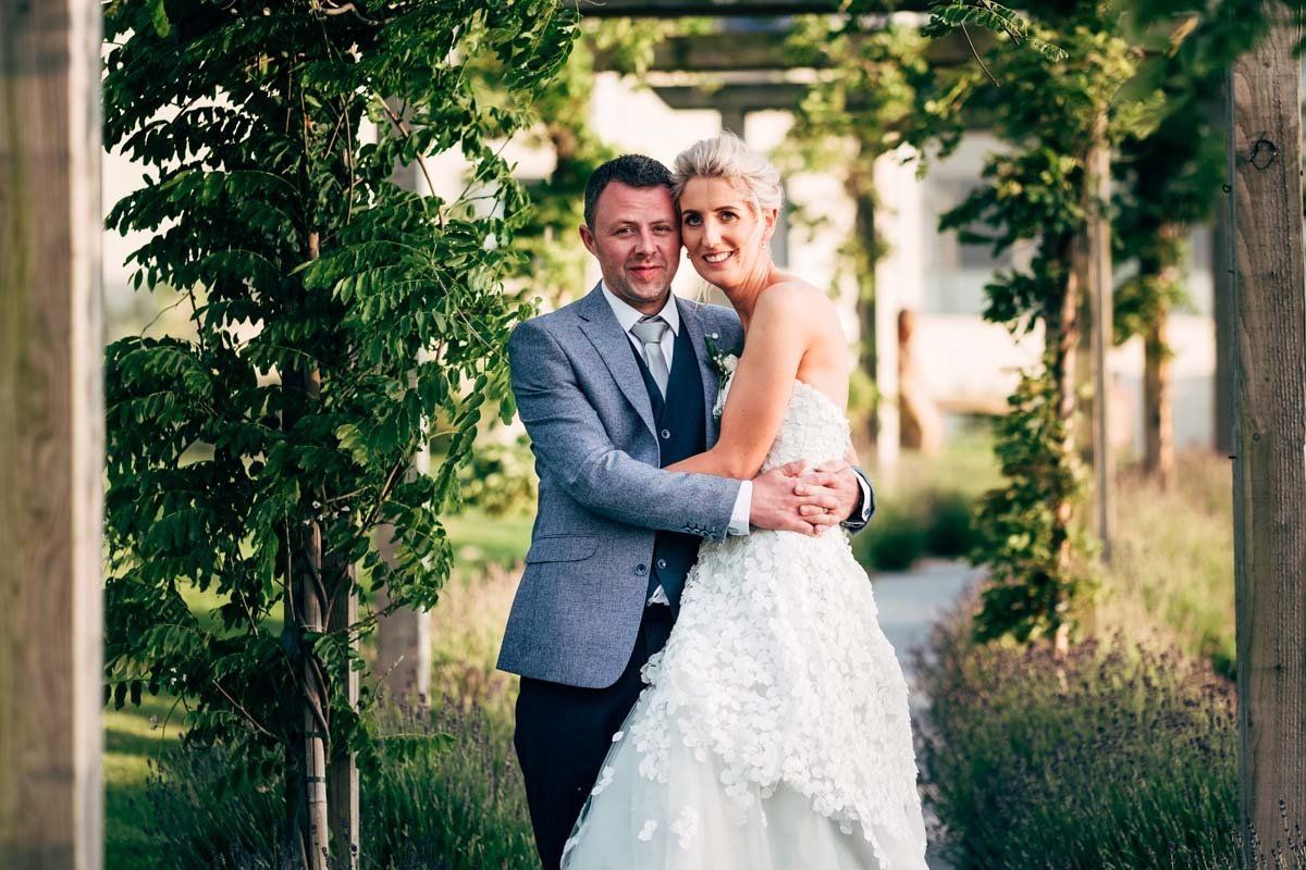 wedding couple embracing under a trellis at Fota Island Resort