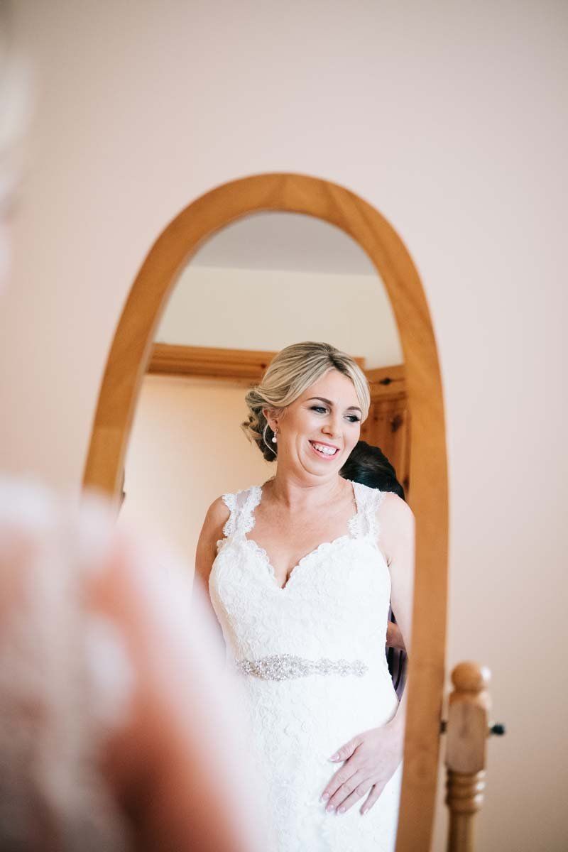 Bride getting ready looking to mirror 