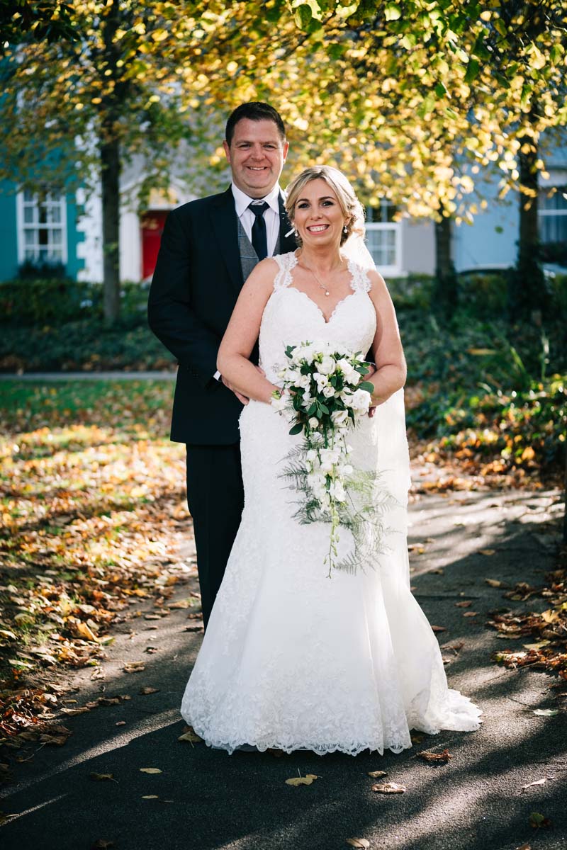 wedding couple in clonakilty Emmet square surround by autumn trees