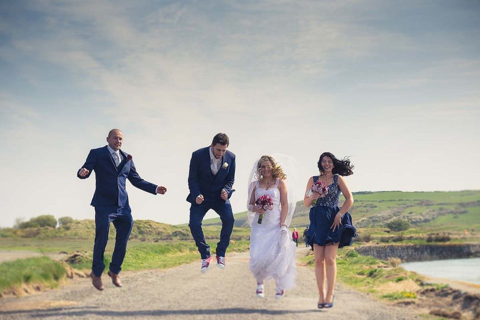 Wedding group jumping in to the air