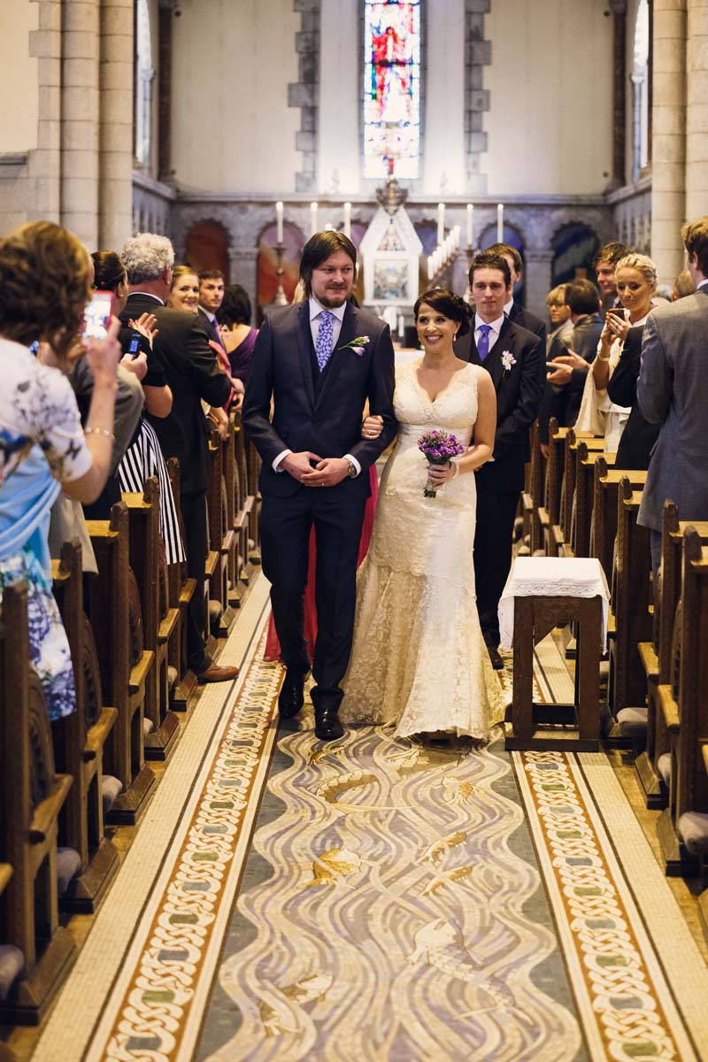 wedding couple walking back down the aisle after the marriage at Honan Chapel UCC