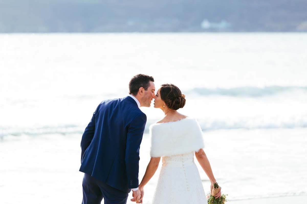 wedding couple kissing on beach at rosscarbery 