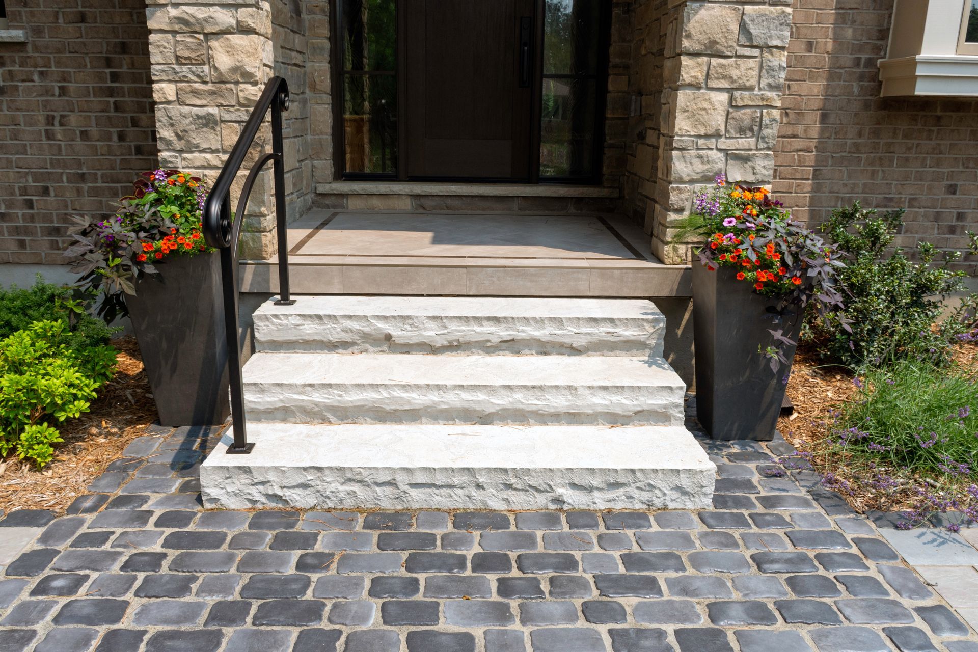 A brick walkway leading to the front door of a house.