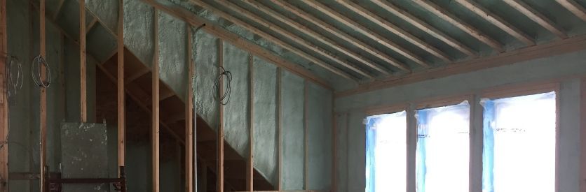 An image of green spray foam insulation installed in a room
