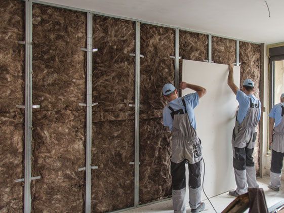 Insulation experts working on installing walls
