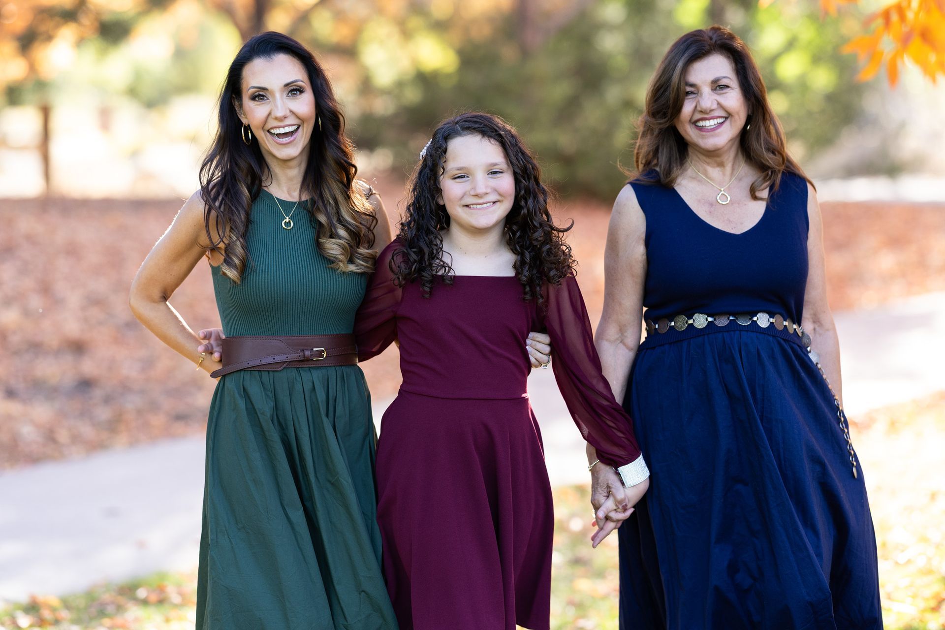 Candid close-up of giggling kids dropping in front of the camera during a spontaneous fall family session.